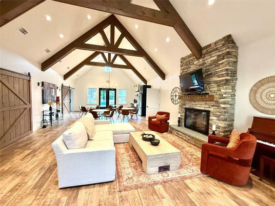 Chandelier, Dining room, Fireplace, Interior, Living room, Recessed Lighting, Stone Walls, Wooden Beams, Wood Texture Flooring