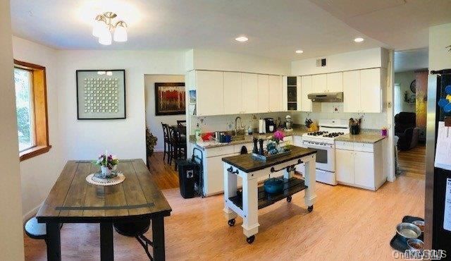Dining room, Interior, Kitchen, Recessed Lighting, Stainless Steel Appliances, Wood Texture Flooring