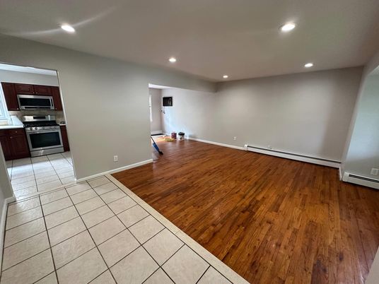 Empty room, Interior, Kitchen, Recessed Lighting, Stainless Steel Appliances, Wood Texture Flooring