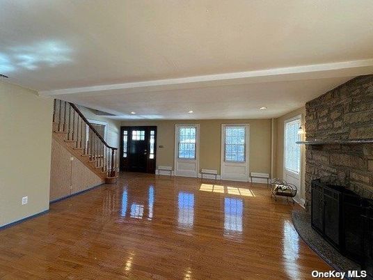 Empty room, Fireplace, Interior, Recessed Lighting, Stone Walls, Wood Texture Flooring