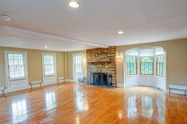 Empty room, Fireplace, Interior, Recessed Lighting, Stone Walls, Wood Texture Flooring