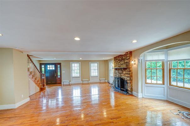Empty room, Fireplace, Interior, Recessed Lighting, Stone Walls, Wood Texture Flooring