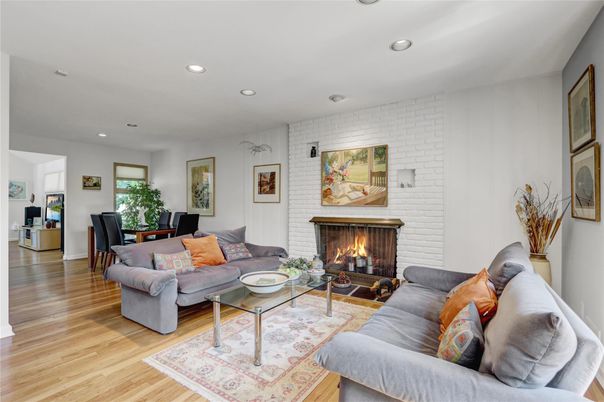 Dining room, Fireplace, Interior, Living room, Recessed Lighting, Stone Walls, Wood Texture Flooring