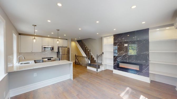Fireplace, Interior, Kitchen, Marble Walls, Pendant Lights, Recessed Lighting, Stainless Steel Appliances, Wood Texture Flooring