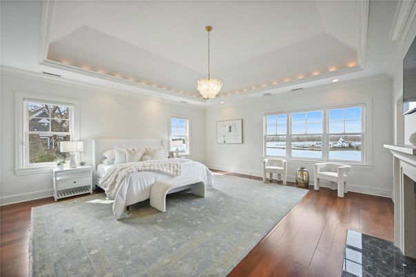 Bedroom, Fireplace, Interior, Pendant Lights, Recessed Lighting, Water, Wood Texture Flooring