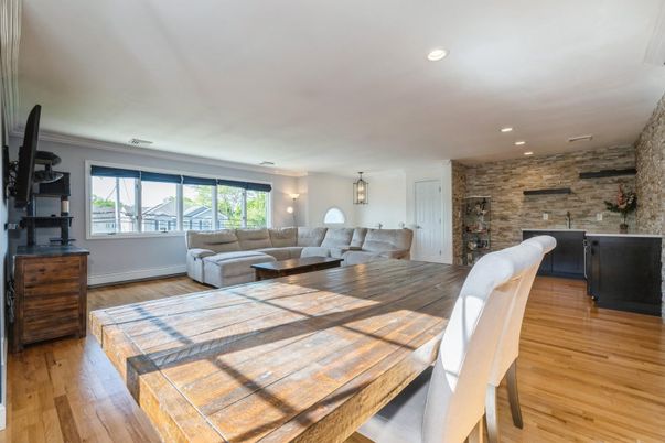Dining room, Fireplace, Interior, Living room, Recessed Lighting, Stone Walls, Wood Texture Flooring