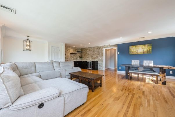 Dining room, Fireplace, Interior, Living room, Recessed Lighting, Stone Walls, Wood Texture Flooring