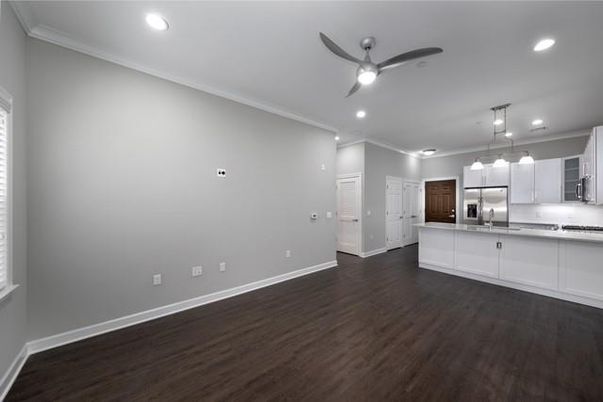 Empty room, Interior, Kitchen, Pendant Lights, Recessed Lighting, Stainless Steel Appliances, Wood Texture Flooring
