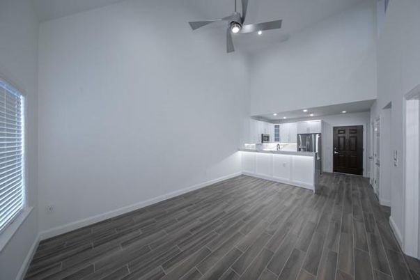 Empty room, Interior, Kitchen, Recessed Lighting, Stainless Steel Appliances, Wood Texture Flooring