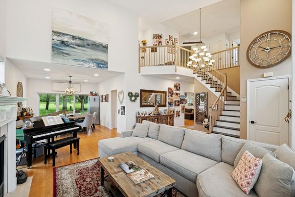 Chandelier, Dining room, Fireplace, Interior, Living room, Pendant Lights, Piano, Recessed Lighting, Wood Texture Flooring