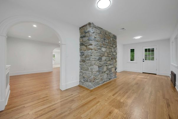 Empty room, Fireplace, Interior, Recessed Lighting, Stone Walls, Wood Texture Flooring