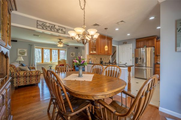 Chandelier, Dining room, Interior, Kitchen, Living room, Recessed Lighting, Stainless Steel Appliances, Wood Texture Flooring