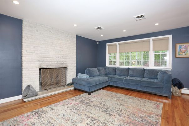 Fireplace, Interior, Living room, Recessed Lighting, Stone Walls, Wood Texture Flooring