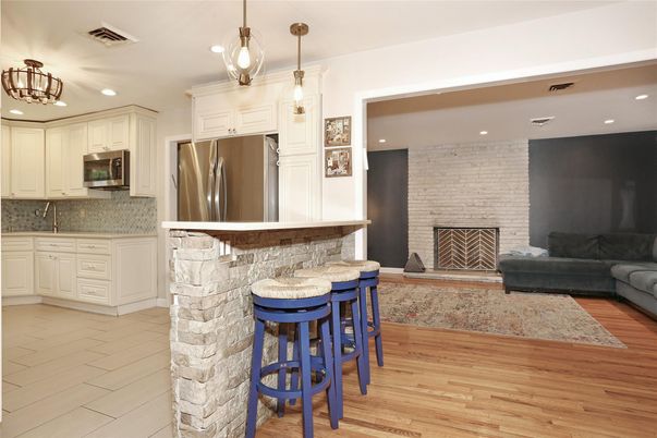 Fireplace, Interior, Kitchen, Pendant Lights, Recessed Lighting, Stainless Steel Appliances, Stone Walls, Wood Texture Flooring
