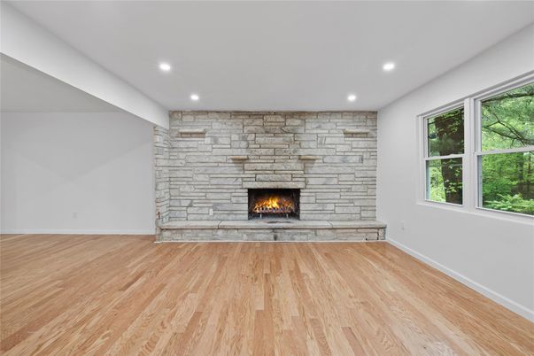 Empty room, Fireplace, Interior, Recessed Lighting, Stone Walls, Wood Texture Flooring