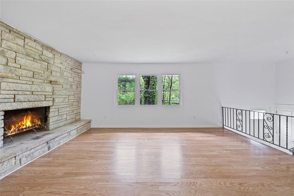 Empty room, Fireplace, Interior, Recessed Lighting, Stone Walls, Wood Texture Flooring