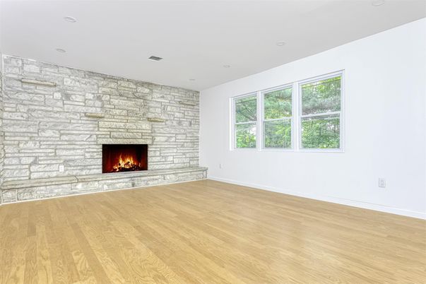Empty room, Fireplace, Interior, Recessed Lighting, Stone Walls, Wood Texture Flooring
