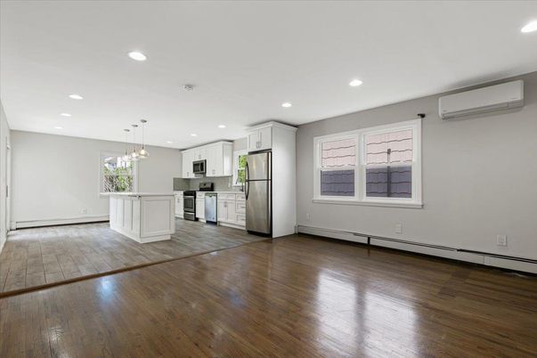 Empty room, Interior, Kitchen, Pendant Lights, Recessed Lighting, Stainless Steel Appliances, Wood Texture Flooring