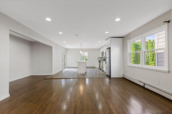 Empty room, Interior, Kitchen, Pendant Lights, Recessed Lighting, Stainless Steel Appliances, Wood Texture Flooring