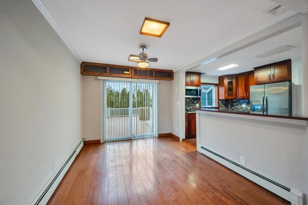 Empty room, Interior, Kitchen, Recessed Lighting, Stainless Steel Appliances, Wood Texture Flooring