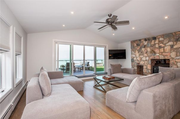 Fireplace, Interior, Living room, Recessed Lighting, Stone Walls, Water, Wood Texture Flooring
