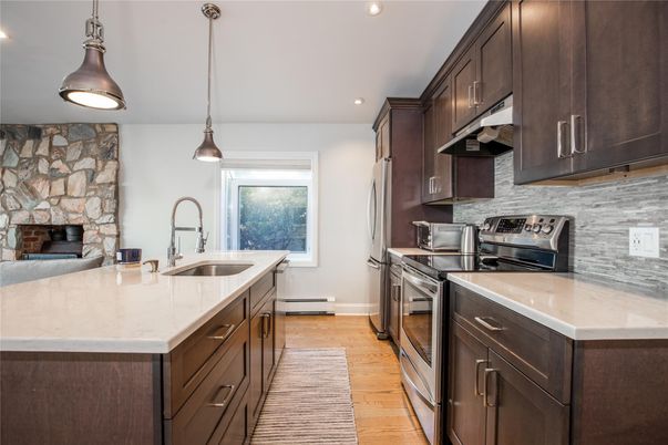 Fireplace, Interior, Kitchen, Pendant Lights, Recessed Lighting, Stone Walls, Wood Texture Flooring