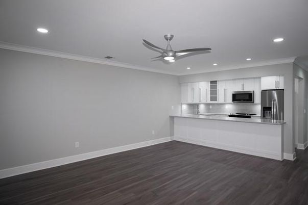 Empty room, Interior, Kitchen, Recessed Lighting, Stainless Steel Appliances, Wood Texture Flooring