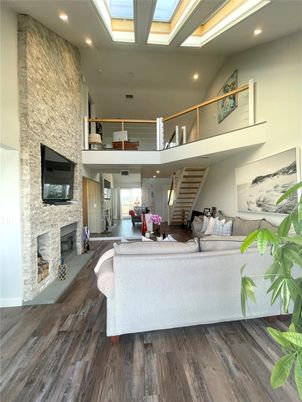 Fireplace, Glass Ceilings, Interior, Living room, Recessed Lighting, Stone Walls, Wood Texture Flooring