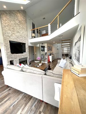Fireplace, Interior, Living room, Recessed Lighting, Stone Walls, Wood Texture Flooring