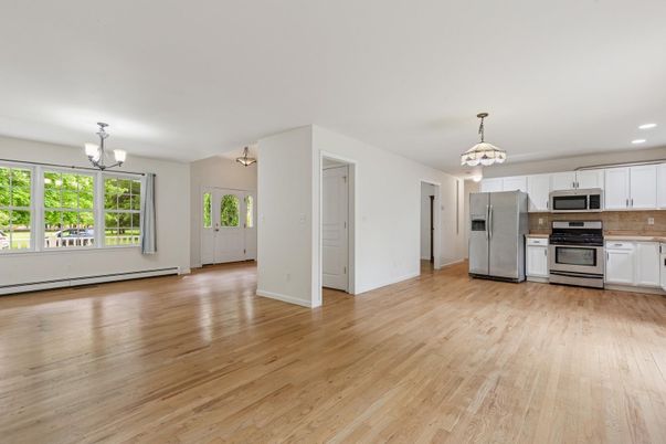 Chandelier, Empty room, Interior, Kitchen, Pendant Lights, Recessed Lighting, Stainless Steel Appliances, Wood Texture Flooring