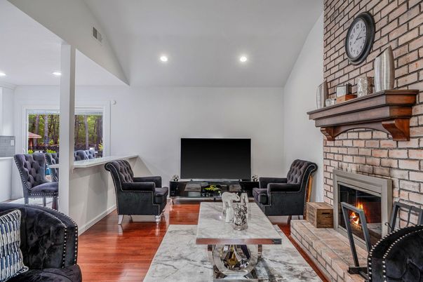 Fireplace, Interior, Living room, Recessed Lighting, Stone Walls, Wood Texture Flooring