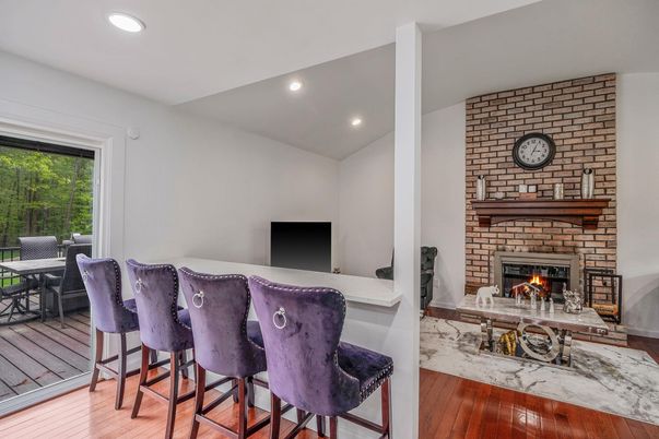 Dining room, Fireplace, Interior, Recessed Lighting, Stone Walls, Wood Texture Flooring