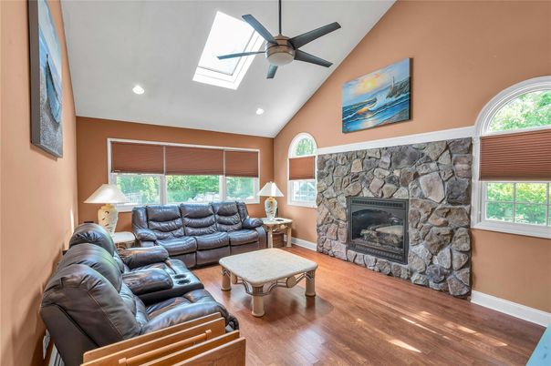 Fireplace, Interior, Living room, Recessed Lighting, Stone Walls, Wood Texture Flooring