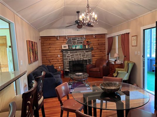 Chandelier, Dining room, Fireplace, Interior, Living room, Stone Walls, Wood Texture Flooring, Wooden Walls