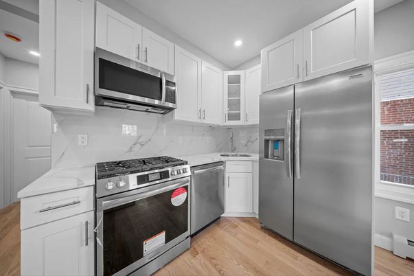Interior, Kitchen, Marble Walls, Recessed Lighting, Stainless Steel Appliances, Wood Texture Flooring