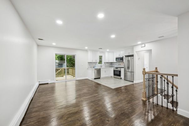 Empty room, Interior, Kitchen, Recessed Lighting, Stainless Steel Appliances, Wood Texture Flooring