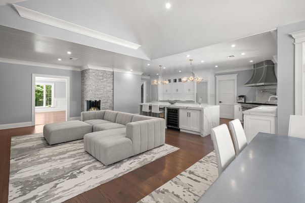 Chandelier, Fireplace, Interior, Kitchen, Living room, Pendant Lights, Recessed Lighting, Stainless Steel Appliances, Stone Walls, Wood Texture Flooring