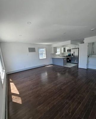Empty room, Interior, Kitchen, Recessed Lighting, Stainless Steel Appliances, Wood Texture Flooring