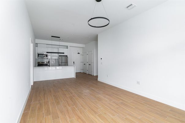 Empty room, Interior, Kitchen, Pendant Lights, Recessed Lighting, Stainless Steel Appliances, Wood Texture Flooring