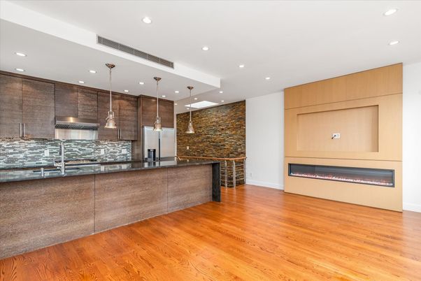 Fireplace, Interior, Kitchen, Pendant Lights, Recessed Lighting, Stainless Steel Appliances, Stone Walls, Wood Texture Flooring