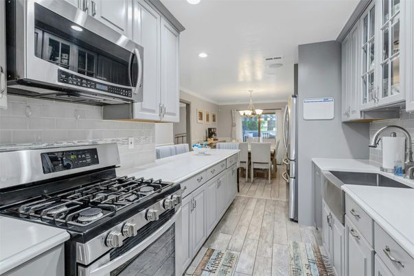 Chandelier, Dining room, Interior, Kitchen, Recessed Lighting, Stainless Steel Appliances, Wood Texture Flooring