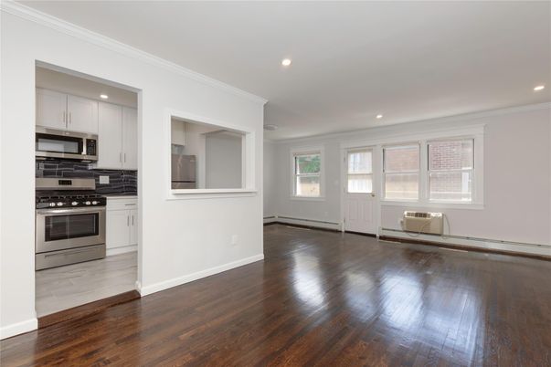 Empty room, Interior, Kitchen, Recessed Lighting, Stainless Steel Appliances, Wood Texture Flooring