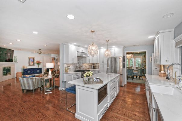 Chandelier, Dining room, Fireplace, Interior, Kitchen, Living room, Pendant Lights, Recessed Lighting, Stainless Steel Appliances, Wood Texture Flooring
