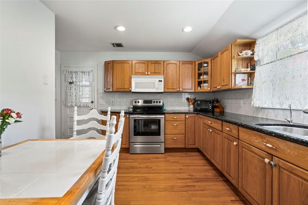 Interior, Kitchen, Recessed Lighting, Stainless Steel Appliances, Tile Countertops, Wood Texture Flooring