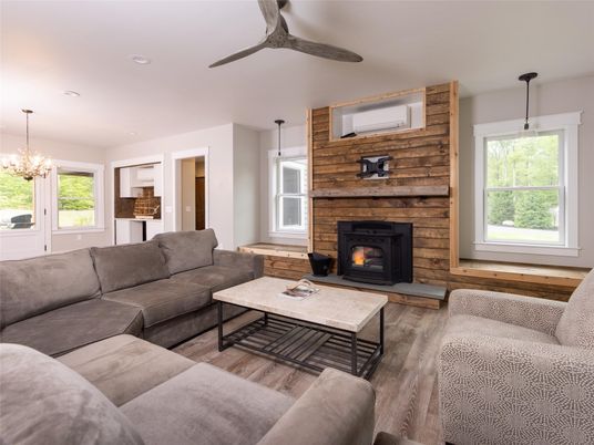 Chandelier, Fireplace, Interior, Living room, Pendant Lights, Recessed Lighting, Stone Walls, Wood Texture Flooring, Wooden Walls