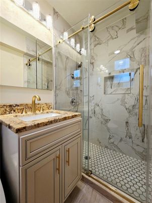 Bathroom, Glass Shower, Interior, Marble Walls, Wood Texture Flooring
