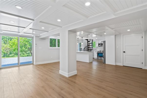 Empty room, Interior, Kitchen, Recessed Lighting, Stainless Steel Appliances, Wood Texture Flooring