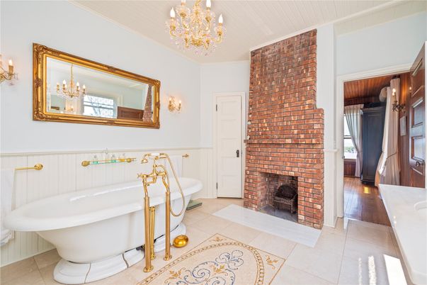 Bathroom, Chandelier, Fireplace, Free Standing Baths, Interior, Stone Walls
