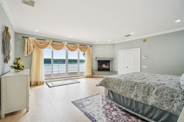 Bedroom, Fireplace, Interior, Recessed Lighting, Water, Wood Texture Flooring