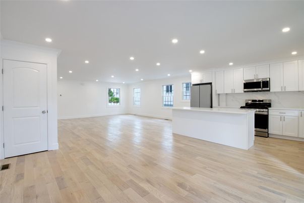 Empty room, Interior, Kitchen, Recessed Lighting, Stainless Steel Appliances, Wood Texture Flooring